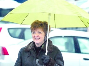 There's nothing we can do about our crazy winter weather, so some residents like Judy Robinson are simply making the best of it. She was doing her best to keep dry while finishing up her regular morning walk in the city Monday. (SCOTT WISHART, The Beacon Herald)