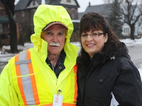 Community 4 Hope volunteer Christie Huckle, right, poses with crossing guard Don Beals nearby London Road school after giving him a number of thank-you gifts Tuesday. More than 40 crossing guards were honoured throughout Sarnia-Lambton as part of a goodwill project recognizing the work crossing guards do in the community. (TYLER KULA, The Observer)