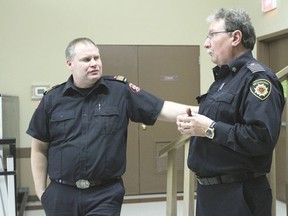 Slave Lake Regional Fire Service chief Jamie Coutts, left, chats with Wetaskiwin Fire Department chief Merlin Klassen following Coutts’ presentation at the emergency management agency meeting Jan. 24. Coutts spoke about the 2011 fires that ravaged the Slave Lake community.