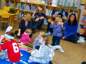 Families enjoying Dr. Seuss read by library staffer Erika Thompson