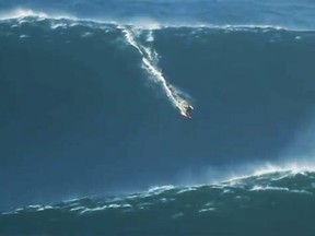 A screen grab taken from Garrett McNamara's documentary shows the American appearing to ride a monster wave.
