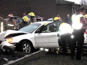 Photo by Ellwood Shreve
Emergency personnel work to extricate a man after his vehicle hit on house on Charing Cross Road, just outside of Chatham, Ont., around 5 p.m. on Tuesday, Jan. 29, 2013.