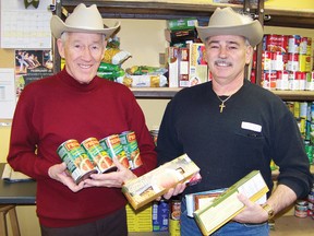 Remi Gillet and Robert Regnier, volunteers at the Agape Centre, hold the required ingredients for the centre’s first spaghetti dinner and show featuring Switchgear for $10 at the Army Navy Club on Feb. 22. 
Staff photo/ERIKA GLASBERG