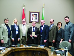 City manager Dale Lyle receives a plaque from Portage la Prairie city council on Monday night for his 19 years of service to the municipality. This was Lyle's last council meeting before retiring.