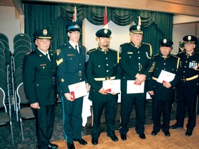 reaty Three Police Service Chief Conrad DeLarond (left) and Deputy Chief Terry Armstrong (right) flank Queen Elizabeth ll Diamond Jubilee Medal recipients Det. Sgt. Doug MacKenzie, Const. Mitchell Boulette, Chief Brian Rupert (retired) and Const. Justin Booth. The medal was also presented posthumously to Mr. Joe Red Thunderboy who was instrumental in the formation of the aboriginal police force and served as chairman of the Treaty 3 police services board for seven years.
REG CLAYTON/Daily Miner and News