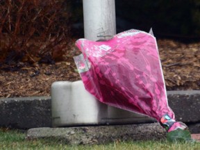 A bouquet has been placed at the base of the flagpole at Johnson Controls Ltd., 100 Townline Road, Tillsonburg. The flag continues to fly at half-mast. Jeff Tribe/Tillsonburg News