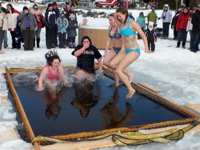 Anne Marshall, Shania Kilpatrick, Heather Cudmore and Joanne Nyman jump for the audience at the annual polar bear dip on Feb. 12, 2012. This was part of the 43rd annual Blind River Winter Carnival held last week. 
FILE PHOTO