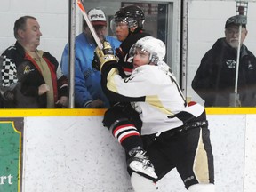 Trenton Golden Hawks' Loren Ulett slams Pickering Panther and former teammate Ian Chen into the end boards during the Hawks' 6-2 win Sunday at the Community Gardens.