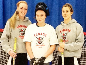 Belleville's Christi McKinney, left, and Tori Chapman, flank Grade 8 student Brianna McRae during a floorball demonstration held this week at Tyendinaga Public School. McKinney and Chapman, along with another Belleville athlete, C.J. Tipping, will play for Team Canada in a women's world championship qualifying event this weekend in Markham.