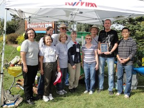 Steve Seko (holding plaque) poses for a photo with members of Twin Brook's community garden. NANCY REMPEL/SPECIAL TO THE EXAMINER