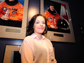 Cassandra Kirk poses in front of a portrait of her hero, astronaut Roberta Bondar, at the Telus World of Science last week. TREVOR ROBB Edmonton Examiner