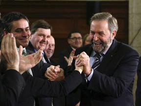 NDP Leader Thomas Mulcair shakes hands with his caucus members at the conclusion of the New Democratic Party (NDP) caucus strategy session on Parliament Hill in Ottawa, January 18, 2013. (REUTERS/Patrick Doyle)