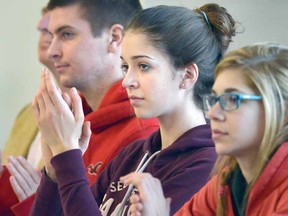 Students including Stratford Central's Alex Andrekovic, centre, applaud at the announcement yesterday of the School Within a University partnership of the Avon Maitland District School Board and the University of Waterloo Stratford campus. (SCOTT WISHART The Beacon Herald)