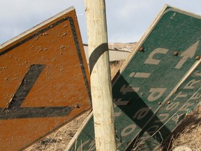 A High River woman left  Hwy. 22 by the Bow River bridge, knocking down a sign and slicing through a barb wired fence before her vehicle rested on its side just metres from the river.