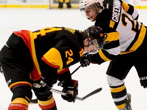 Belleville Bulls centre Garrett Hooey and Kingston Frontenacs centre Darcy Greenaway, a former Wellington Duke, battle for the puck during OHL action Wednesday night at Yardmen Arena. (Michael J. Brethour for The Intelligencer.)