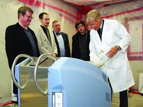 Dr. Michael Shannon, director of medical affairs with C3 Contamination Control Corporation, demonstrates the new AsepticSure decontamination system to (l-r) Bob Simpson, company co-founder, Dylan Simpson, lead crew chief, Gardiner McBride, managing director and co-founder, and Rory Nauman, technical analyst.     ROB MOOY - KINGSTON THIS WEEK