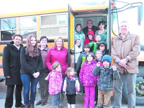 Staff, volunteers, and kids who attend the Salvation Army Friends Club welcomed a big yellow bus that will help transport kids to the after-school program, thanks to the generosity of Sean Payne at Martin's Bus Service (right).