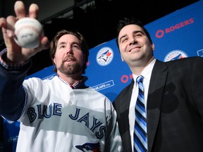 Blue Jays general manager Alex Anthopoulos introduces Toronto Blue Jays' newly acquired knuckleballer R.A. Dickey during a press conference at the Rogers Centre in Toronto January 8, 2013. Photo by Dave Abel/Toronto Sun/QMI