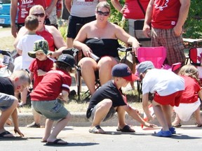Kids scramble to pick up candy at the Canada Day parade in Sarnia, July 1, 2012. (QMI Agency file photo)