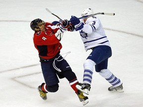 Alex Ovechkin (L) of the Washington Capitals is checked off the puck by Toronto Maple Leafs defenceman Dion Phaneuf during their game in Washington March 11, 2012. REUTERS/Kevin Lamarque