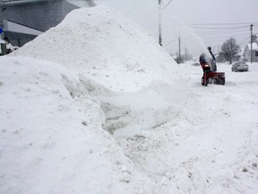 Timmins resident Armand Perron is dwarfed by a monster snowbank as he attacks his neighbour's driveway with a snowblower. “There’s now shortage of the white stuff today,” said Perron with a laugh.