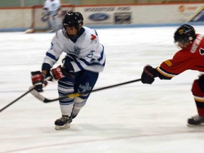 Woodstock forward Christian Babb gets around Paris Mounties forward Cole Cummings in an earlier game this season between the two teams. Woodstock opens up their first-round series against the Mounties tonight at Southwood Arena at 7:45 p.m. Game 2 is set for Saturday night in Paris. GREG COLGAN/QMI Agency/Sentinel-Review