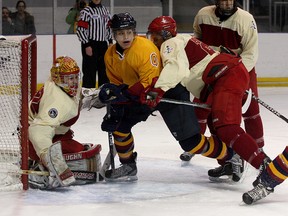 Royal Military College Paladins’ Scott McDonald tries to get Queen’s Golden Gaels’ Jordan Soquila away from goaltender Paul Dorsey during the 27th annual Carr-Harris Challenge Cup game at the K-Rock Centre on Thursday night. The Gaels won the game 7-2. (Ian MacAlpine/The Whig-Standard)