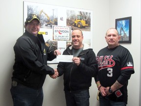 Shane Moffatt accepts a cheque for $1,500 from Mark Moon and Jack Meseyton of EF Moon Construction. The funds will go towards purchasing a new ice plant for the BDO Centre for the Community. (ROBIN DUDGEON/PORTAGE DAILY GRAPHIC)