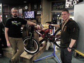 Devon Bicycle Association (DBA) president Kevin Haugjord (left) with DBA member and area resident Mackenzie Haut with one of two bicycles Haut donated to the club. The bikes are to be subsequently donated to two deserving local riders, yet to be determined.