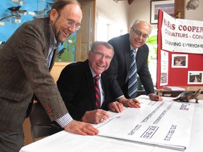 Local MP Guy Lauzon, centre, endorses a cheque of $125,000 for Cooper Marsh Conservators' Dr. Robin Poole, left, and Jacques Legault on Friday at the Cooper Marsh Visitor Centre. GREG PEERENBOOM staff photo