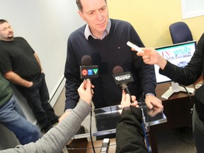 Painter Brent Tremblay speaks to reporters Friday during a news conference at Nipissing MPP Vic Fedeli's constituency office to launch a campaign against legislation requiring mandatory coverage for the construction industry under the   Workplace Safety and Insurance Board.
