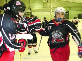Members of Cree Nation celebrate a goal in their tournament opener on Friday. There was plenty of time to celebrate, as the Bears beat Ottawa West 10-3.