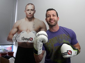 Craig Clement, co-president of Hayabusa at his west end office with a cardboard cut out of mixed martial arts fighter Georges St. Pierre. 
Ian MacAlpine The Whig-Standard