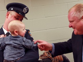 Toronto Mayor Rob Ford meets six-month-old Liam Easby during the intro of 40 new Toronto firefighters Friday, Feb. 1, 2013. (Dave Thomas/Toronto Sun)