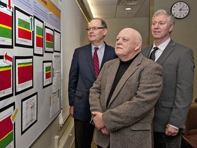 Brantford General Hospital board of directors (from left) chair Paul Moore, governance committee chair Tom Lockyer and vice-chair Jon Lynne-Davies look at a performance measurement board in the hospital's boardroom. (BRIAN THOMPSON The Expositor)