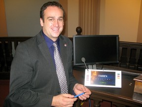 Mayor Mark Gerretsen shows off some of the high-tech upgrades that have been installed in council chambers in City Hall.