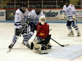 Woodstock forward Matt Jauernig and defenceman Ben Thornton screen Paris goalie Zach Shompe who looks behind him after kicking out a pad save in their Feb. 1, 2013 playoff game. The Mounties would go on to win game 1 5-1 at Southwood Arena. (GREG COLGAN, Sentinel-Review)