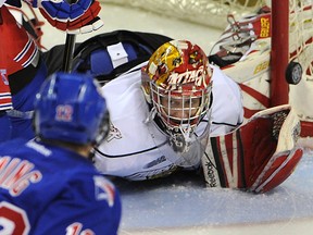 Kitchener’s Eric Ming just misses the net with Owen Sound Attack goalie, Jordan Binnington down in his net during an Ontario Hockey League game in Kitchener on Friday.