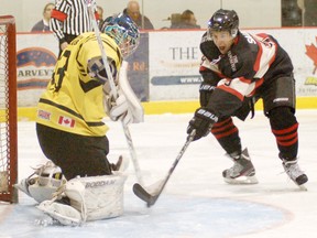 Brantford Blast forward Cam Sault nearly tips the puck by Whitby Dunlops goalie Anthony Kimlin Friday during Allan Cup Hockey action at the civic centre. (DARRYL G. SMART The Expositor)