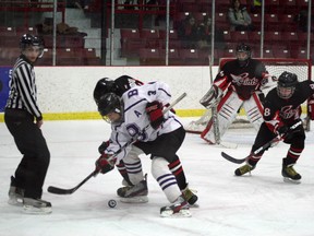 A Beaver Brae Broncos forward battles St. Thomas Aquinas Saints defenders in first period play at Thistles Pavilion, Friday, Feb. 1, 2013.