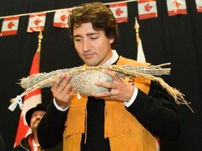 Svjetlana Mlinarevic/Portage Daily Graphic
Justin Trudeau smells sweet grass he received as a gift during his visit to Long Plain First Nation's Keeshkeemahquah Conference and Gaming Centre in Portage la Prairie on Thursday. Trudeau was in town to get the aboriginal vote during his campaign for the Liberal leadership.