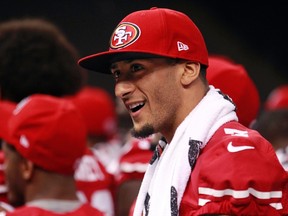 49ers quarterback Colin Kaepernick walks to take his team picture during Super Bowl XLVII media day in New Orleans, La. Jan. 29, 2013. The Ravens will have to reduce his ability to run while not opening too many holes if they want a chance to beat him Sunday. (JOE SKIPPER/Reuters)