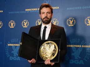 Ben Affleck poses for photographers with the Feature Film Award at the 65th annual Directors Guild of America Awards in Los Angeles, February 2, 2013. (REUTERS/Phil McCarten)