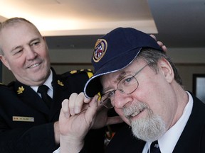 Toronto Sun Ian Robertson paid his respects to Toronto Police Chief Bill Blair shortly before his retirement. Blair gave Robertson a Toronto Police cap as a souvenir. (STAN BEHAL, Toronto Sun)