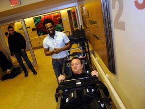 Dr. Tosin Akinbiyi (left), an orthopedic and spine surgeon at Queen Elizabeth II Hospital, shows off the works of a brand new Jackson Spine system with the help of QEII Foundation chairman Scott Lissoway on Friday. (Adam Jackson/Daily Herald-Tribune)
