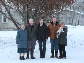 Audrey and Bennie Everton (left), their son Rob (middle right), his wife Gisela (centre) and sister Colleen holding Duchess pose for a family photo at their farm, just outside of Hythe. The County of Grande Prairie has chosen the Evertons as Farm Family of the year for 2013.  (Photo courtesy of the County of Grande Prairie)