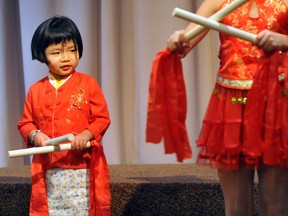Kate Kuri, 4, casts an eye over to the older girls performing a traditional dance during the Chatham-Kent Chinese Association's annual New Year celebration in Chatham, On., Sunday February 03, 2013. DIANA MARTIN/ THE CHATHAM DAILY NEWS/ QMI AGENCY