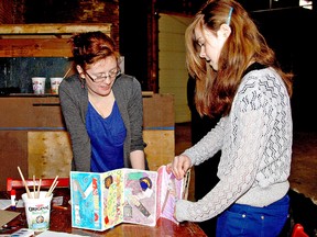 KARA WILSON, for The Expositor

Art teacher Rachel Beales helps Morgan Goodine, 13, put the final touches on her name art collage on Saturday during grand opening activities for the Brantford Arts Block's new home at 111 Sherwood Dr.