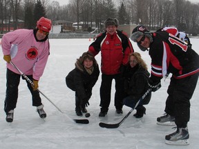 South Stormont's deputy-mayor Tammy Hart,  Coun. Richard Waldroff and tournament organizer Audrey Dante-Hickman gather to drop the puck at the pond hockey tournament in Long Sault.