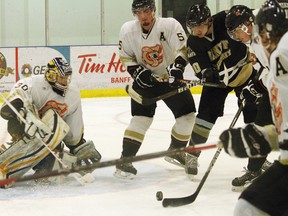 The Banff Bears' Michael Harbich is in the right place at the right time, but the Coaldale Copperheads' Bryce D'Agnone holds him up preventing the goal on Sunday, Feb. 3, 2013. Banff lost 3-2, and now faces the Cochrane Generals on Friday for a decisive playoff battle. LARISSA BARLOW/ BANFF CRAG & CANYON/ QMI AGENCY